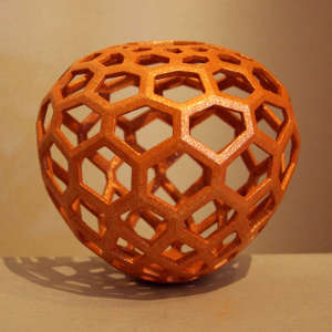 Perforated orange micaceous sculptural piece