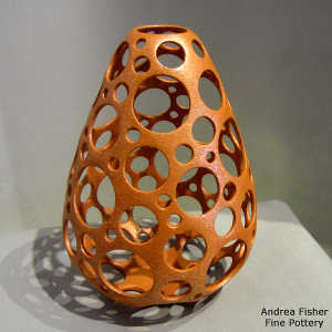 Golden micaceous jar with perforations