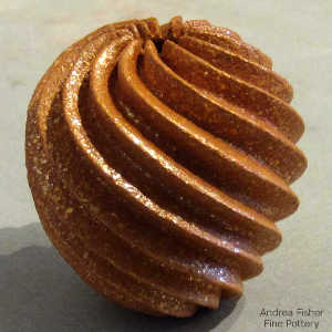 Spiral cut deep carving on a miniature golden micaceous seed pot