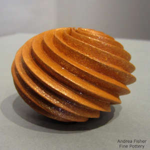 Spiral design carved deep into a red micaceous pot