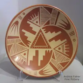 3-panel kiva step and geometric design in tan on a red plate
