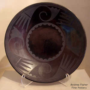 Bird element and geometric design on a black on black plate