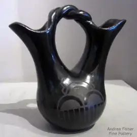 A geometric design on a black-on-black wedding vase with a twisted handle