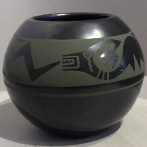 Green slip avanyu design on a black jar