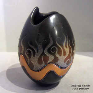 Inlaid heishe beads and a sgraffito geometric design on a polychrome jar with an organic opening