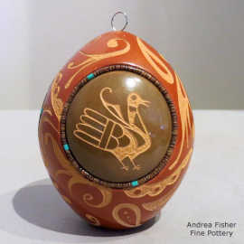 Inlaid heishe beads and a sgraffito bird and geometric design with three green medallions on a red seed pot also with a sgraffito design