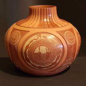 Carved geometric design and sgraffito avanyu and geometric design on a red on red jar