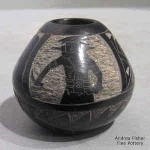 Sgraffito Yei, dancer, pueblo, feather and geometric design on a miniature black jar