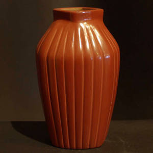 Rectangular ribs and a rotated opening on a tall red jar