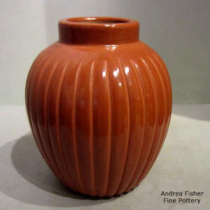 Carved ribs on a tall red jar