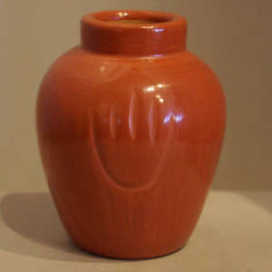 Bear paw imprint on a polished red jar