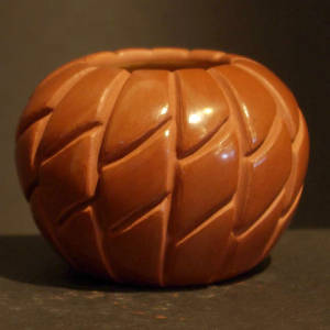 Sunflower design carved into a red jar