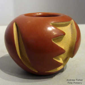 Geometric design carved into a red jar