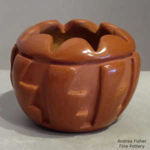 Geometric design carved into a red jar