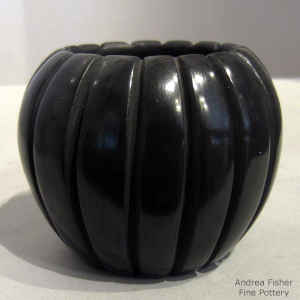 Carved black melon jar