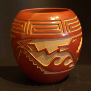 Avanyu, kiva step and spiral geometric designs carved into a red jar
