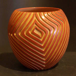 Geometric designs carved into a red jar