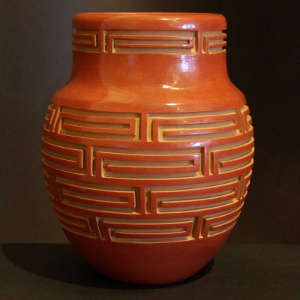 Scroll geometric designs carved into a red jar