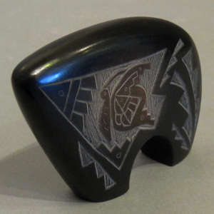 Sgraffito butterfly and geometric design on a black bear with sienna spot