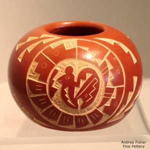 Sgraffito butterfly and quail medallions on a red bowl