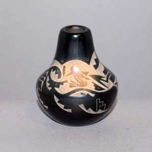 Sgraffito avanyu, hummingbird and geometric design on a black jar with a sienna spot
