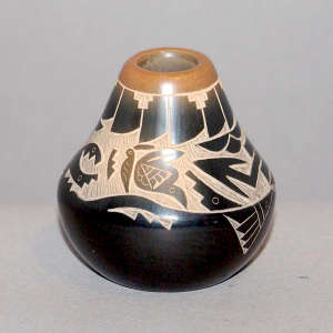 Sgraffito avanyu, butterfly and geometric design on a black seed pot with a sienna rim