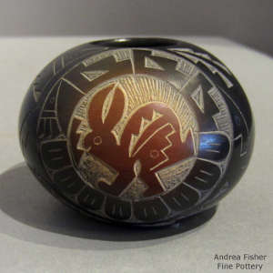 Sgraffito rabbit, Yei and geometric design on a black jar with sienna spots