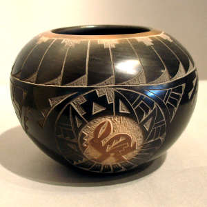 Sgraffito rabbit, feathers and bird element design on a polished black jar with sienna spot