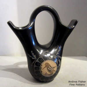 Sgraffito geometric designs surround hummingbird and Yei sienna medallions on a black wedding vase