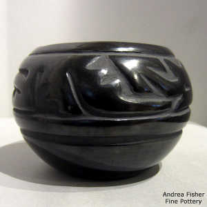 An avanyu design carved into a black bowl