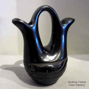 Black wedding vase carved with an avanyu design