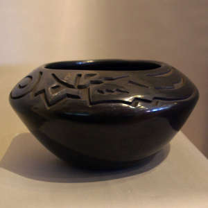 Avanyu design carved into a black jar