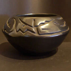Avanyu design carved into a black bowl