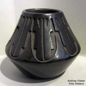 Geometric design carved into a black jar
