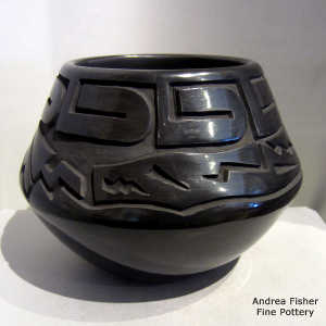 Avanyu and geometric design carved into a black jar