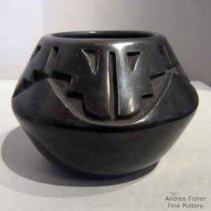 A kiva step and geometric design carved into a black jar