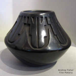 A geometric design carved into a black jar