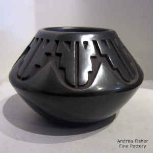 A geometric design carved into a black jar