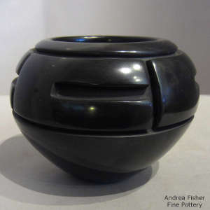 Geometric design carved into a black jar