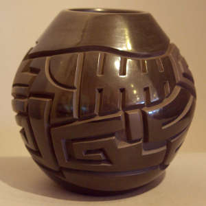 Geometric design carved into a polished black jar