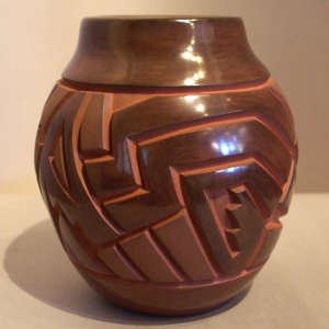Geometric design carved into a red jar