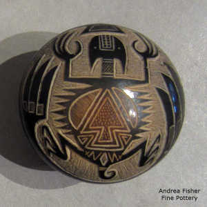 Sgraffito feather, horned toad and geometric design on a black seed pot with sienna spots