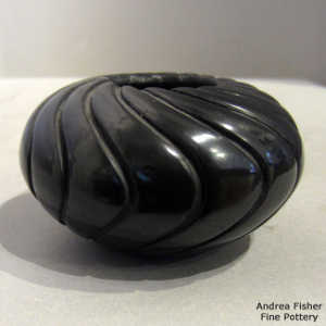 Swirl design carved into a black melon jar
