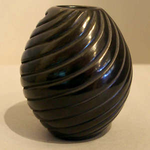 Spiral design carved into a black jar