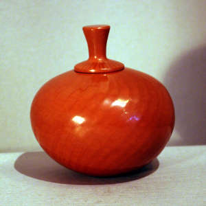 Faceted red jar with a lid