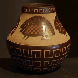 Sgraffito fish and geometric designs on a polished brown jar