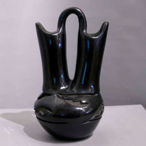 Avanyu and geometric design carved into a black wedding vase