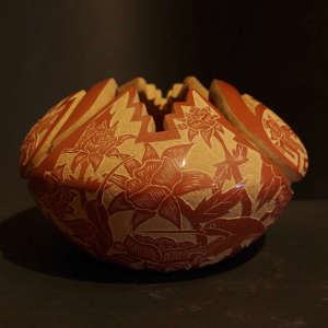Sgraffito hummingbird and floral design on a carved red jar with a kiva step opening