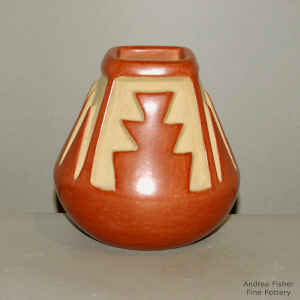 Red vase with a square opening and carved geometric design