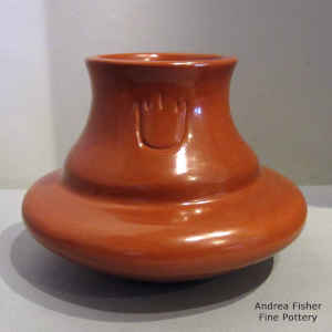 Bear paw imprints on a red water jar